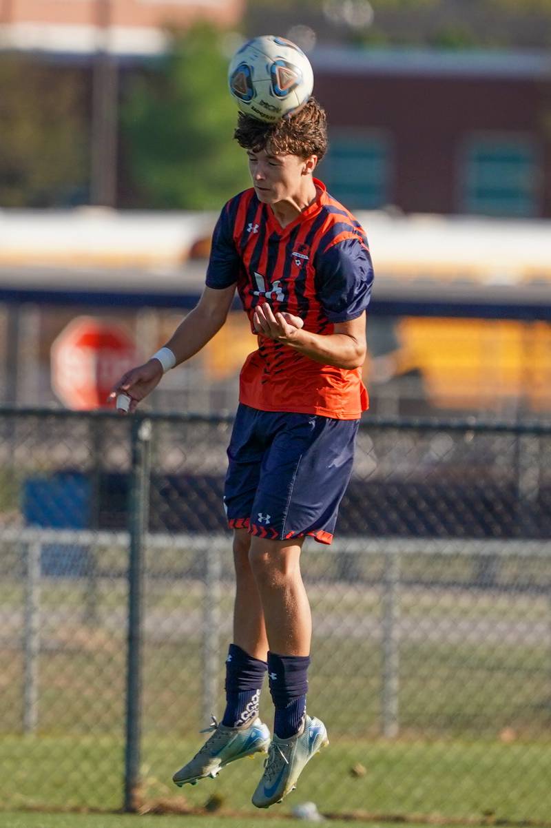Oswego’s Dustin King (16) goes up for a header during a soccer match against Oswego East at Oswego High School on Tuesday, Oct. 1, 2024.