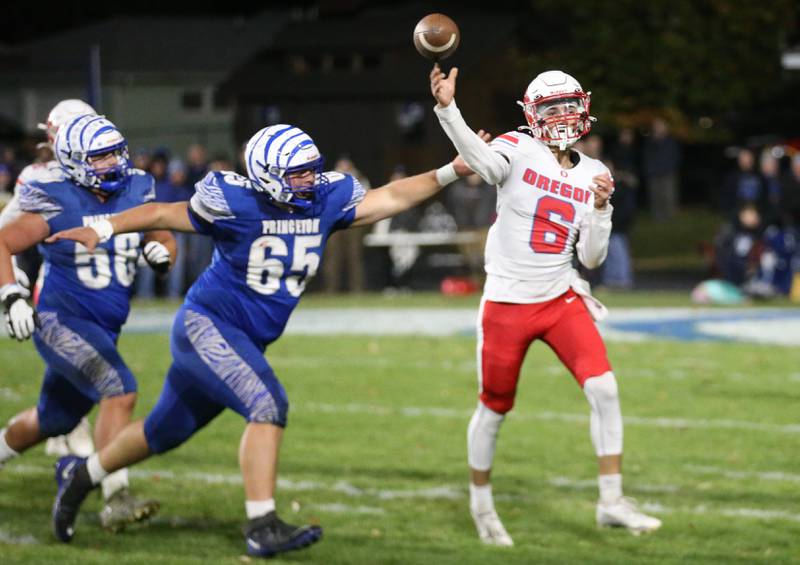 Oregon quarterback Benny Olalde lets go of a throw as Princeton's Cade Odell reaches out to grab his shoulder during the Class 3A playoff game on Friday, Nov. 1, 2024 at Princeton High School.