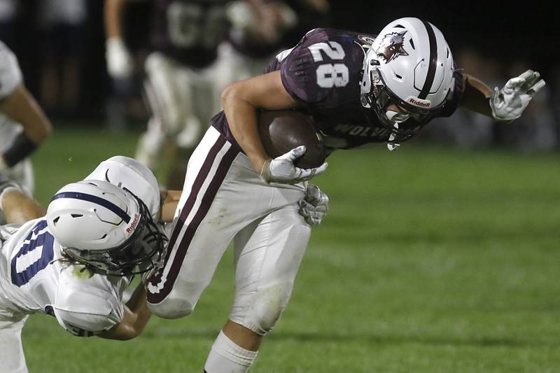 Cary-Grove's Landon Moore tackles Prairie Ridge's Jackson Torkelson after a long pass play in the fourth quarter during a Fox Valley Conference football game on Friday, Sept. 27, 2024, at Prairie Ridge High School.