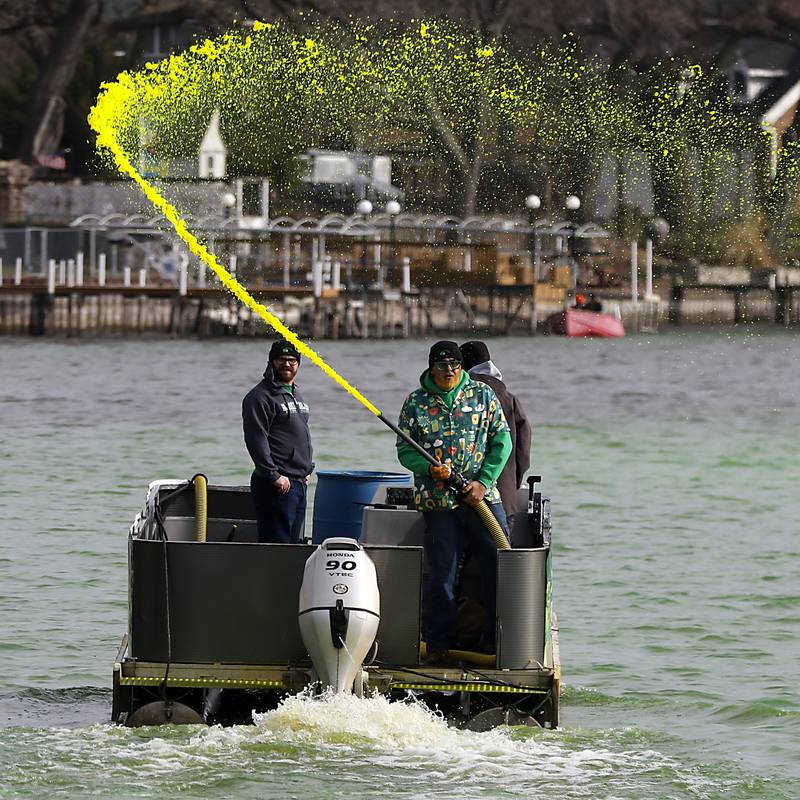 Dye is sprayed into the Fox River to dye the river green during the McHenry’s ShamROCKS the Fox Festival on Saturday, March 16, 2024.