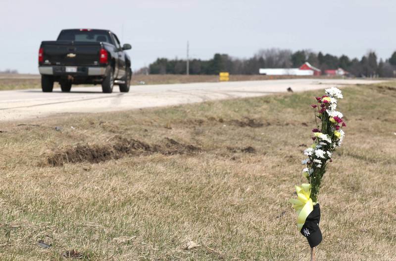 Ruts in the grass and skid marks can be seen near a memorial Friday, March 29, 2024, at the site on Route 23 three-quarters of a mile south Perry Road, near DeKalb where DeKalb County Sheriff’s Deputy Christina Musil, 35, died in a crash while working a shift Thursday night.
