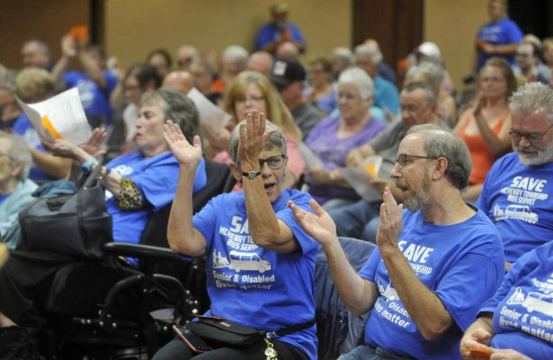 Sue Rose, of Wonder Lake, center, celebrates the passing of Resolution #092019, to fund the senior bus service Friday evening, Sept. 20, 2019, during a McHenry Township Special Annual Town Meeting for the purpose of transferring McHenry Township general funds for the benefit of senior citizens in McHenry Township by funding the senior bus program through March 31, 2020.