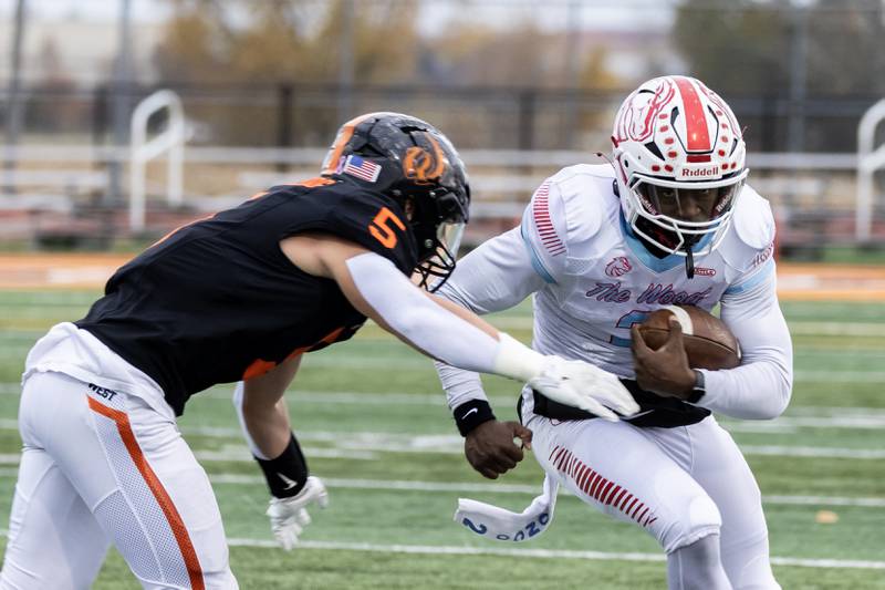 Kenwood's Kenyonte Louis picks-up yardage during a 7A varsity football playoff game against Lincoln-Way West at Lincoln-Way West on Nov. 8, 2025.