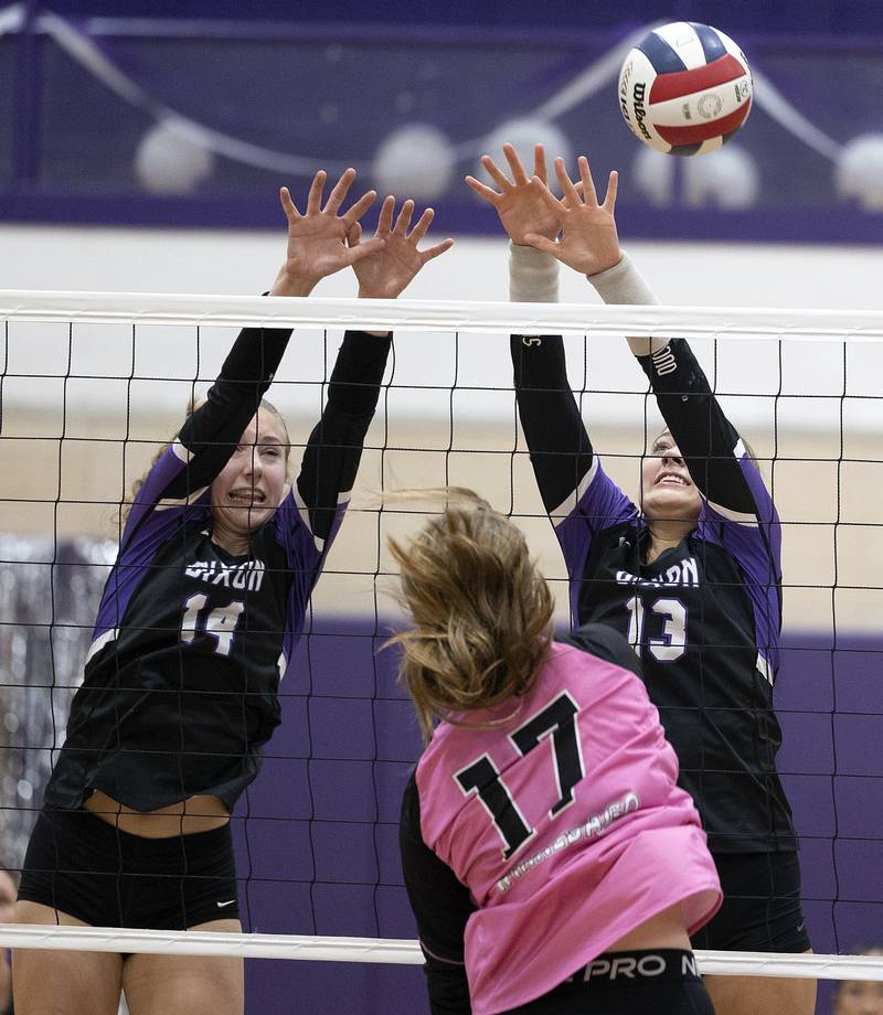 Dixon’s Leah Carlson (left) and Solis Thompson work to block a shot against Winnebago’s Hannah Bertram Tuesday, Oct. 22, 2024, in Dixon.