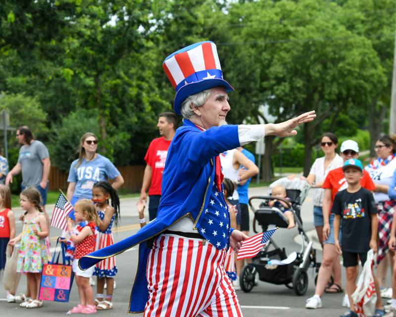 Uncle Sam waves to community members during the Independence Day parade on Friday July 4, 2025, held in downtown Downers Grove.