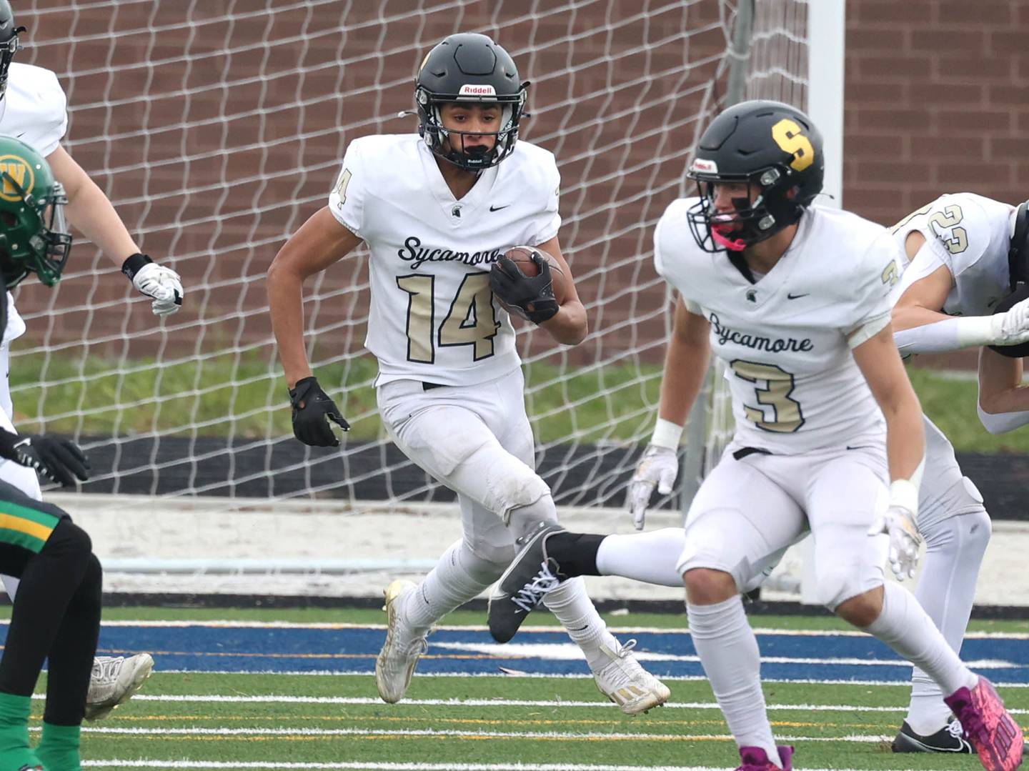 Sycamore's Josiah Mitchell carries the ball through a hole in the Westinghouse line Saturday, Nov. 9, 2024 during their Class 5A second-round playoff game at Knute Rockne Stadium in Chicago.