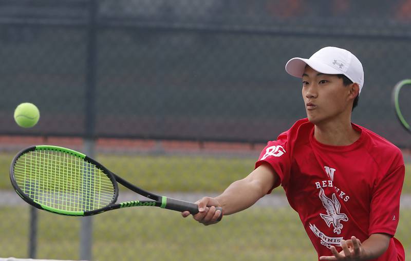 Naperville Central’s Peter Paik returns the ball during an IHSA 2A boys doubles tennis match Thursday, May 25, 2023, at Buffalo Grove High School.