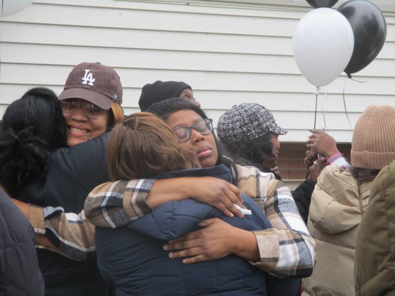 Cara Esters (center) shares her grief at a Sunday vigil for the deaths of seven people, including two of Esters' sisters, on Jan 21 on West Acres Road in Joliet. Jan. 28, 2024.