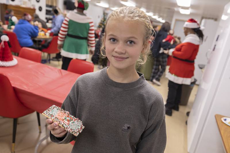 Zaryah Boyd, 12, displays her decorated Christmas cookie Wednesday, Dec. 11, 2024, at the Whiteside County Senior Center.