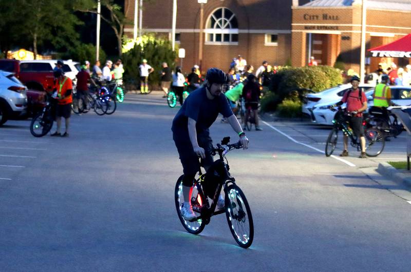 Riders prepare for the Raue Center for the Arts Night Owl Bike Ride in Crystal Lake on Saturday, August 2, 2025.