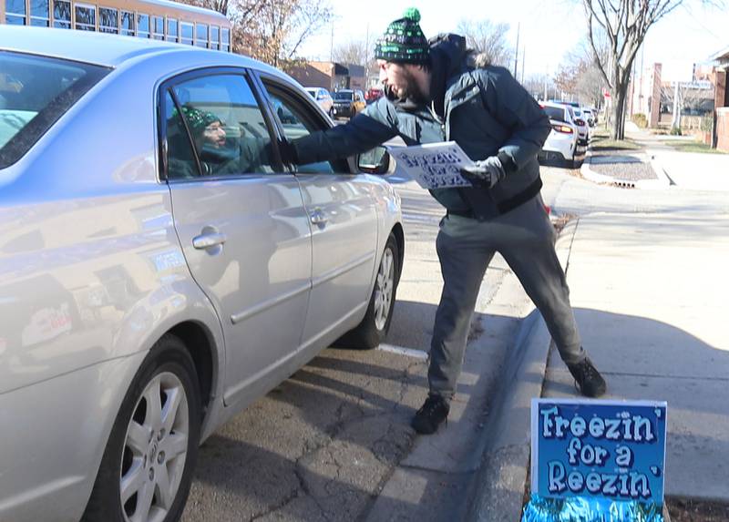 Kyle Wilkinson of Otttawa, collects donations for the annual Freezin' for a Reezin' event on Friday, Dec. 6, at WCMY downtown Ottawa. The all-day event to helps the Ottawa Community Food Basket.