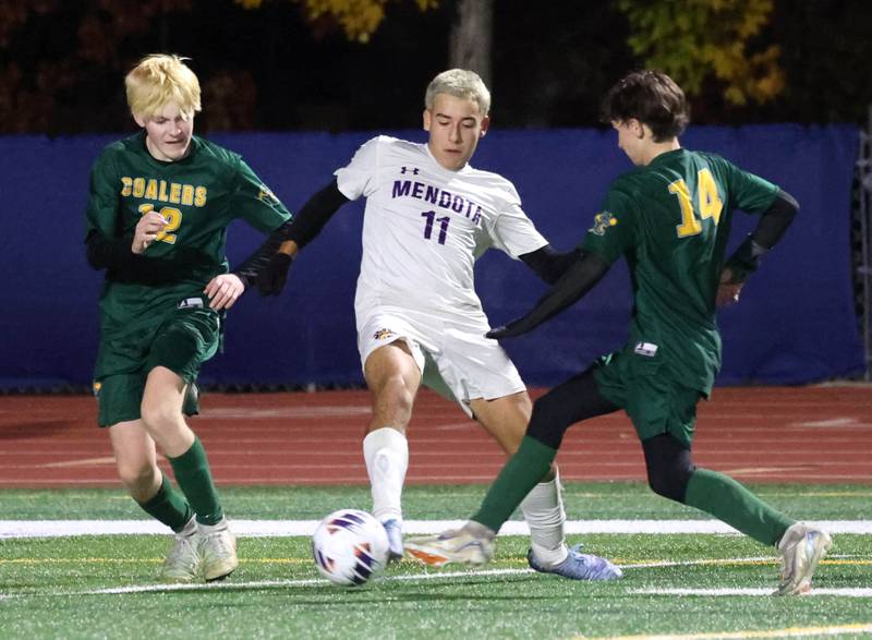 Mendota's Cesar Casas tries to get between Coal City's Carter Hollis (left) and Creed Macaluso Thursday, Nov. 6, 2025, during their Class 1A state semifinal game at Hoffman Estates High School.