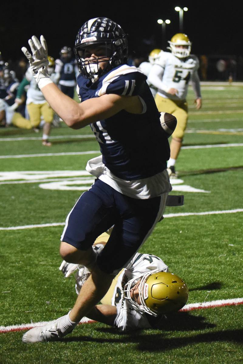 IC Catholic's Grant Bowen breaks a tackle attempt from Bishop McNamara's Micah Lee during an IHSA Class 3A second round playoff game at IC Catholic Friday, Nov. 7, 2025.