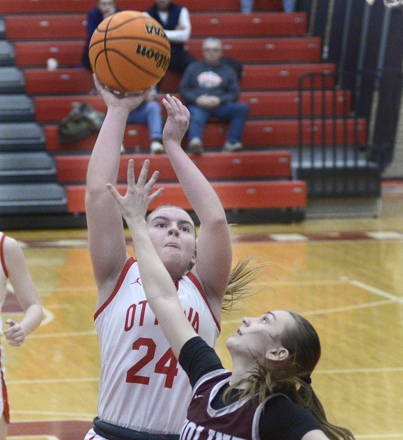 Ottawa’s Kennedy Kane gets a shot away as Moline’s Adalynn Voss attempts to block in the 1st period Tuesday at Ottawa.