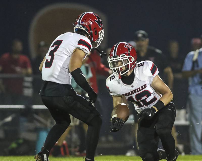Yorkville's Dillon Viscogliosi (12) comes up with an interception during football game between Yorkville at Oswego Friday, Sept 26, 2025 in Oswego.