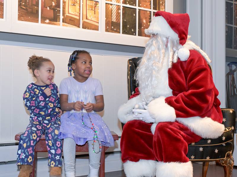 Scarlett, 3 and Norah Stob 6, of St. Charles visit Santa at the Geneva Visitor Center on Saturday, Dec 20, 2025 in Geneva.