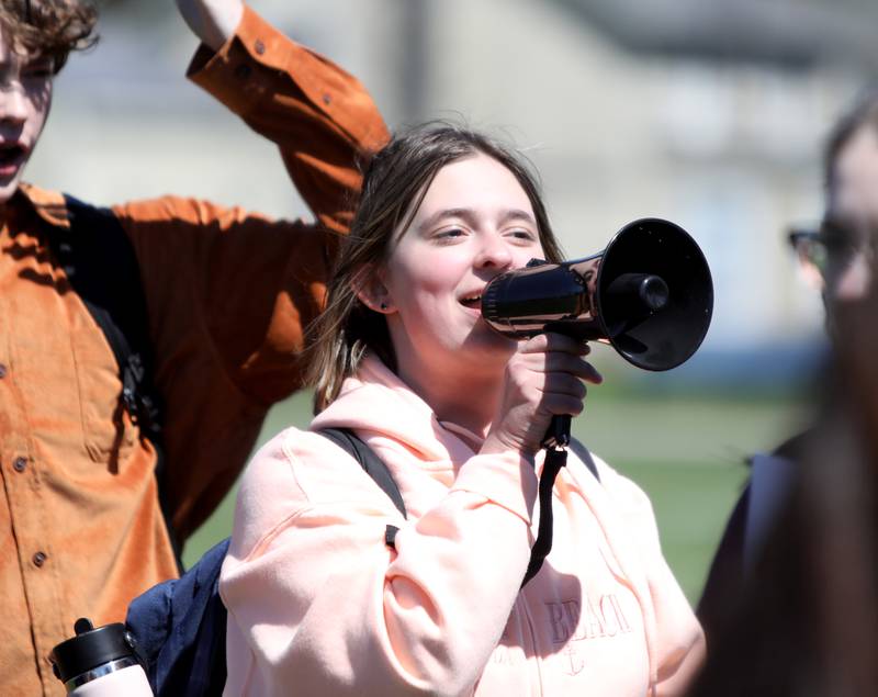 Ellie Carter, one of the Batavia High School Students Against Gun Violence club organizers, talks during a peaceful protest on Friday, April 19, 2024.
