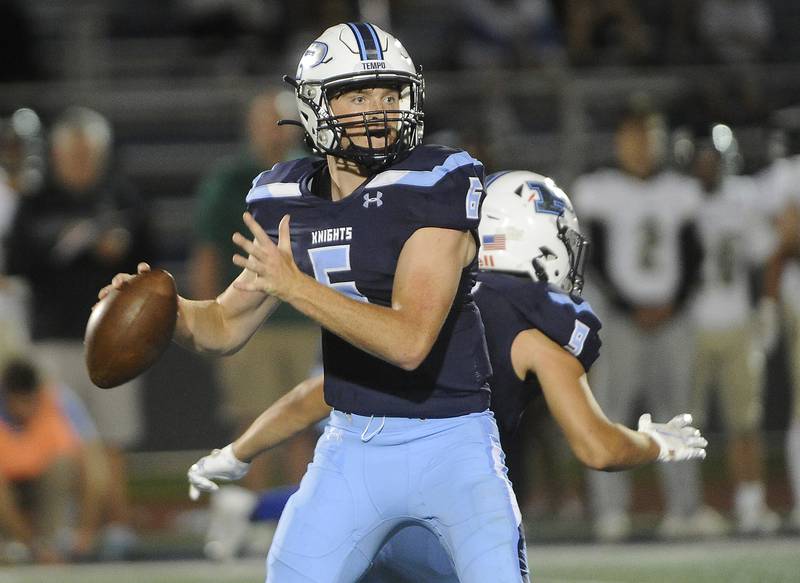 Prospect's quarterback Frank Covey looks for Jacob Parisi downfield in the second quarter in varsity football against Fremd at Prospect on Friday.