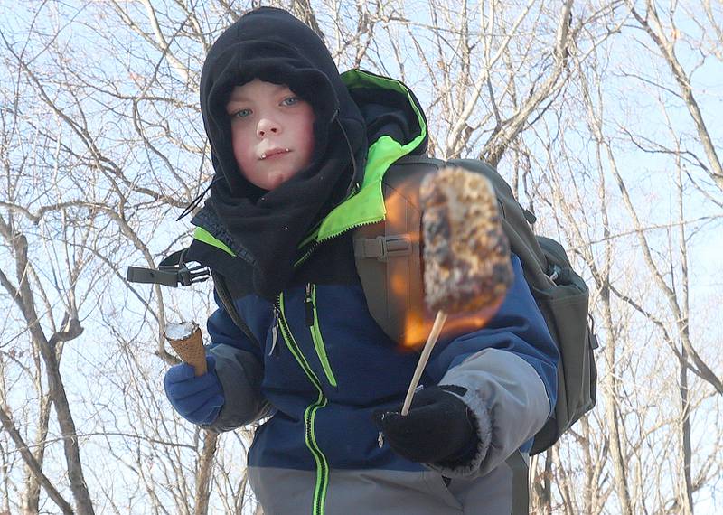 RJ Havenar of Mendota, toasts a marshmallow while making s'mores during the Lowaneu Cub Scout Yukon on Saturday, Jan. 31, 2026 at Hall Township Echo Bluff Park in Spring Valley.