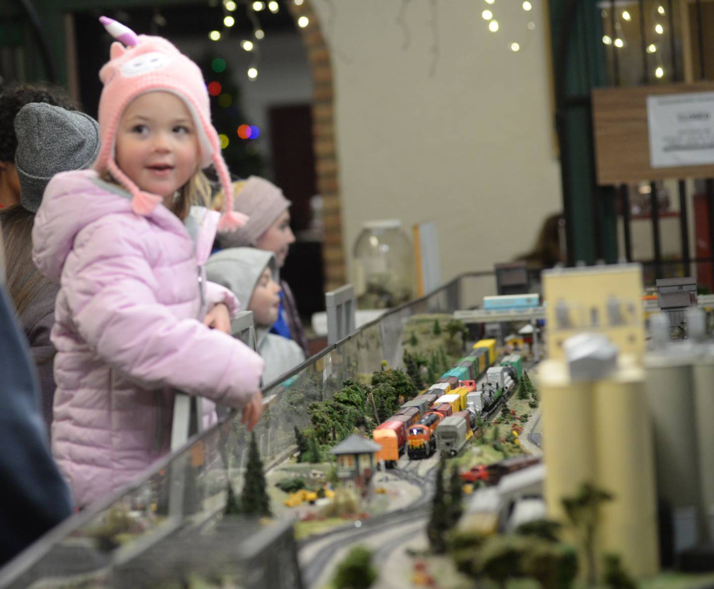 Mia Flaharty, 4,  of Oregon, watches a model train with her dad at the Blackhawk Model Railroad Club at Conover Square during Oregon's Candlelight Walk on Saturday, Nov. 25. 2023. The evening event also included Christmas music, shopping specials, and visits with Santa.