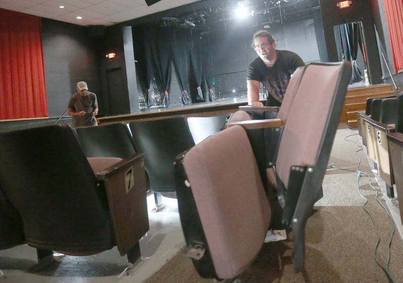 Will Daugherty removes Stage 212 seats to the lobby with Natalie Smigel on Tuesday, Aug. 12, 2025 in La Salle. A church in Kalamazoo Mich. will be picking up the seats this weekend.