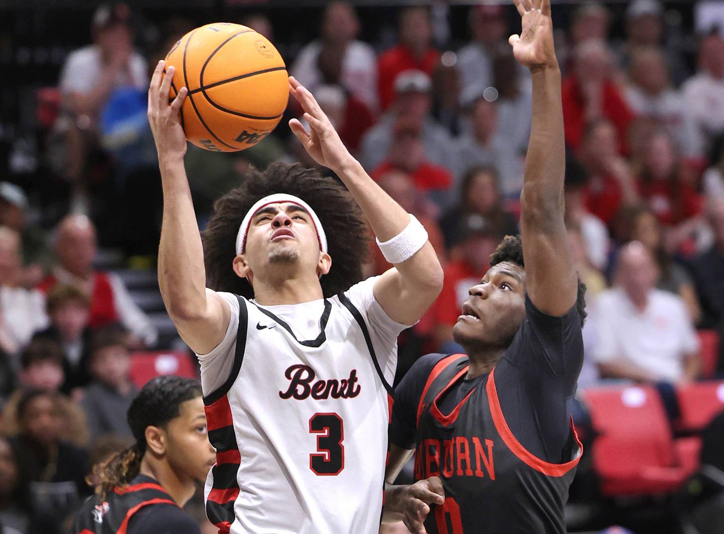 Benet's Jayden Wright goes to the basket in front of Auburn's Mikwan Marshall Monday, March 9, 2026, during their IHSA Class 4A supersectional matchup in the Convocation Center at Northern Illinois University in DeKalb.