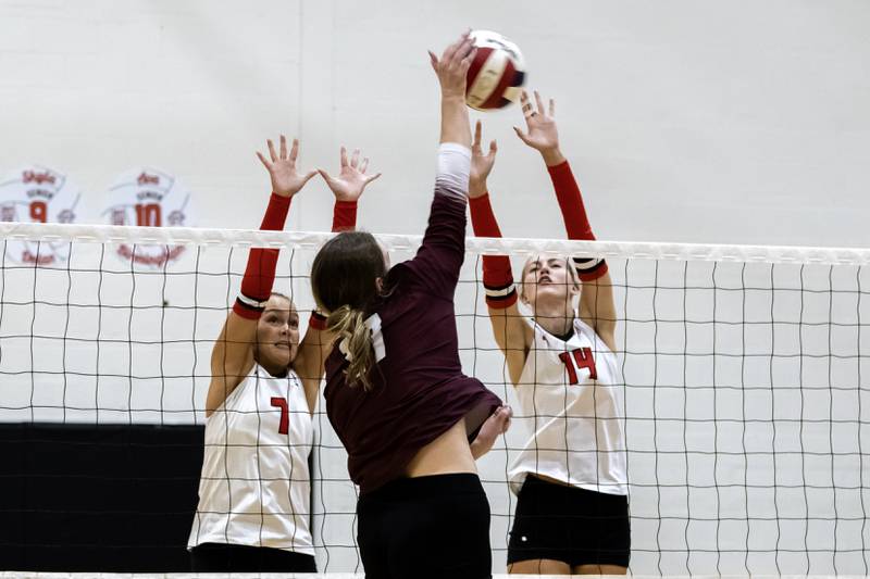 Lincoln-Way Central's Penny Smith and Ella Thompson attempt to block a hit from Lockport's Bridget Ferriter during a varsity volleyball game at Lincoln-Way Central on Oct. 9, 2025.