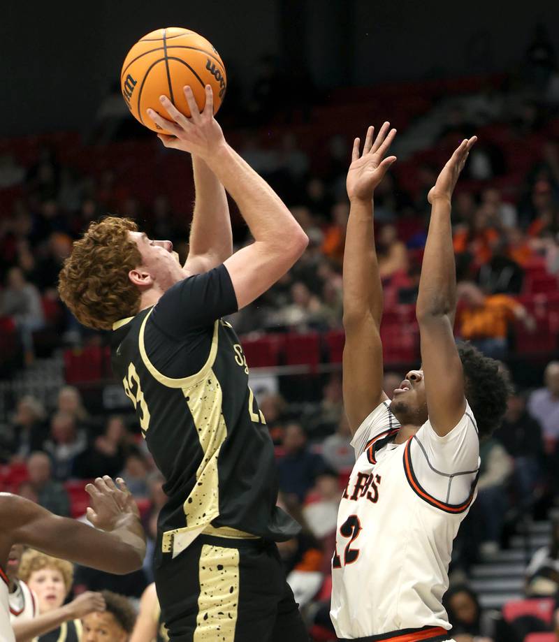 Sycamore's Aidan Mesenbrink shoots over DeKalb's Derrion  Straughter Friday, Jan. 30, 2026, during the FNBO Challenge at the Convocation Center at Northern Illinois University in DeKalb.