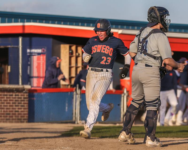 Oswego's Conor Tully (23) scores a run during baseball game between Plainfield South at Oswego on Monday, April 14, 2025 in Oswego.