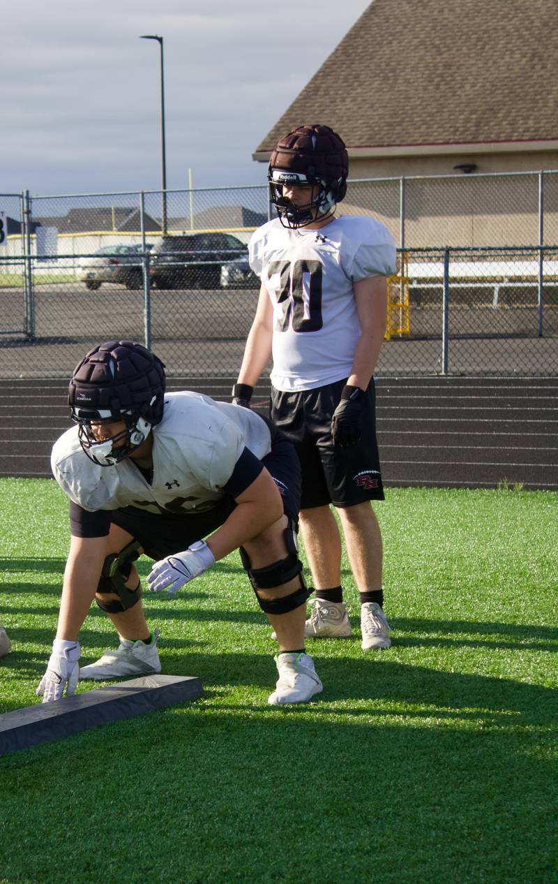 Plainfield North's Dominic Fasano (center)