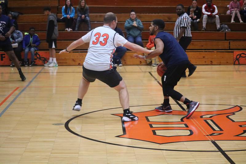 Andrew Sperry (left) defends Ray Hernandez at half court Dec. 4, 2023 during the annual Guns and Hoses Basketball Game put on at Huntley Middle School in DeKalb.