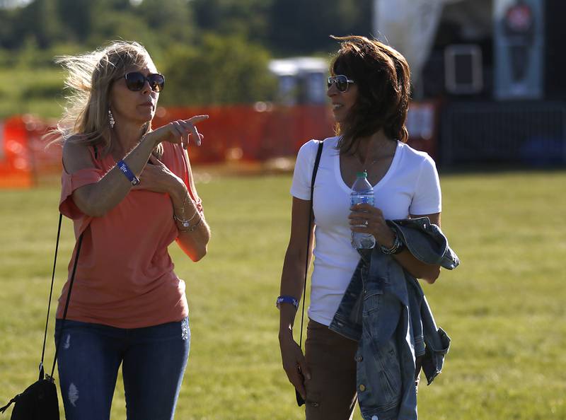 Kelly Hannapel and Judy Ferneau discus dinner options during the Algonquin Founders’ Days Festival Friday, July 29, 2022, at Ted Spella Community Park, 2610 Harnish Drive, in Algonquin. This year marks the festival’s 60th anniversary that includes over 40 events, including live music, food and drinks, a carnival, and market bazaar. The festival runs from 2 to 11 p.m. July 30 and 10 a.m. to 9 p.m. July 31. A Founders’ Day Christmas in July Parade will run through Main Street in downtown Algonquin beginning at 11 a.m. July 30.