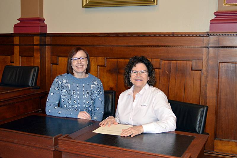 Lee County Zoning Administrator Dee Duffy, right, and Renewable Energy Coordinator Alice Henkel pose for a photo in the county board room on Dec. 27, 2023. Duffy is retiring on Jan. 2, 2024, after which Henkel will take over as zoning administrator.