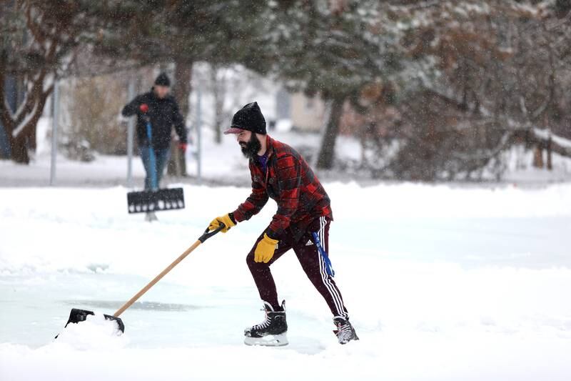 Sugar Grove Park District employee David Del Giudice clears snow from the ice rink on Friday, Jan. 10, 2025 behind the Sugar Grove Township Community Building. The rink, which is possible through a partnership between the Sugar Grove Park District, Sugar Grove Township Sugar Grove Fire Protection District and Village of Sugar Grove,  is frozen and ready for skaters.