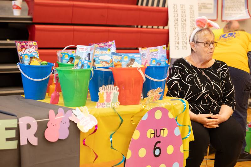 Kathy Piacenti hands out Easter egg baskets at the annual Easter Egg hunt on Saturday, April 12, 2025 at Hall High School in Spring Valley.