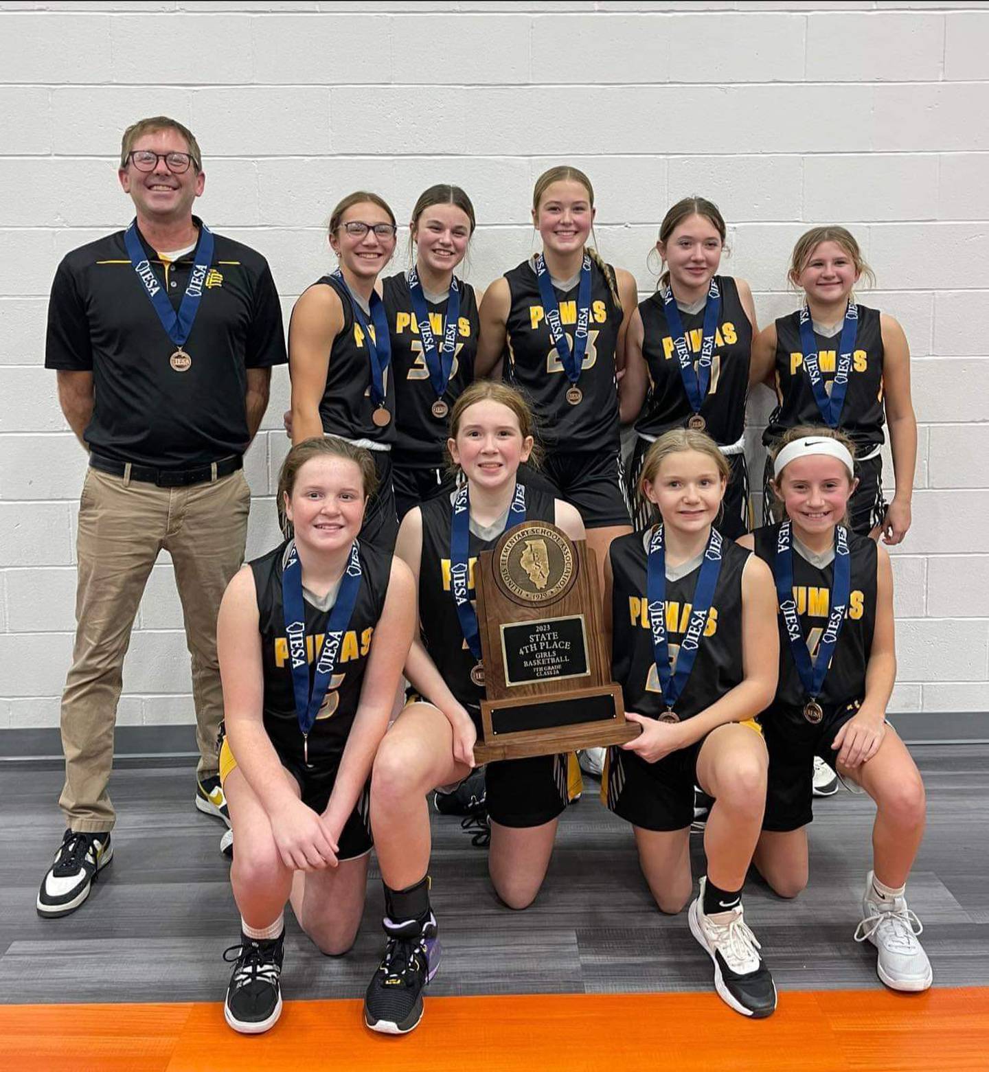 The Putnam County seventh grade girls basketball team placed fourth in the IESA Class 2A state tournament. Pictured, back row (left to right): Coach Nick Heuser, Hannah Heiberger, McKlay Gensini, Tula Rue, Millie Harris and Avery Lenkaitis. Front row: Murphy Hopkins, Kami Nauman, Makenna Wrobleski and Anniston Judd.