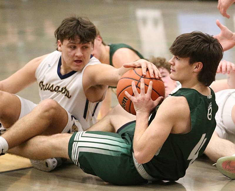 St. Bede's John Brady gains possession of a loose ball as Marquette's Alex Graham fails to get it back in the Class 1A Regional semifinal on Wednesday, Feb. 22, 2023 at Midland High School.