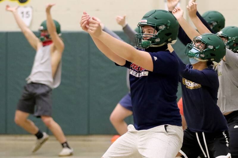 Nathan Compere practices drills with the team during the first day of football practice at Crystal Lake South High School on Wednesday, March 3, 2021 in Crystal Lake.