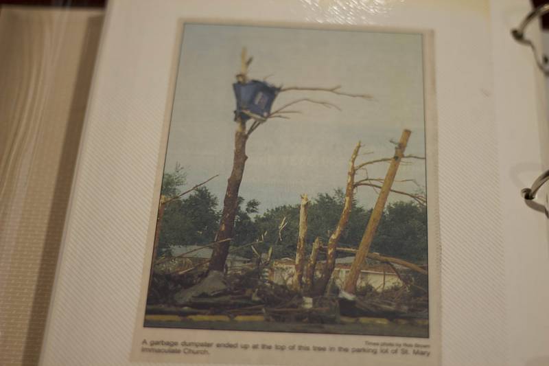 A photo of garbage dumpster on trees stripped by bare by the 1990 tornado in Plainfield. The photo is among many photos and articles kept in album by Retired Beecher Deputy Fire Chief Jerry Conner, one of the firefighters from Beecher who responded to the incident.