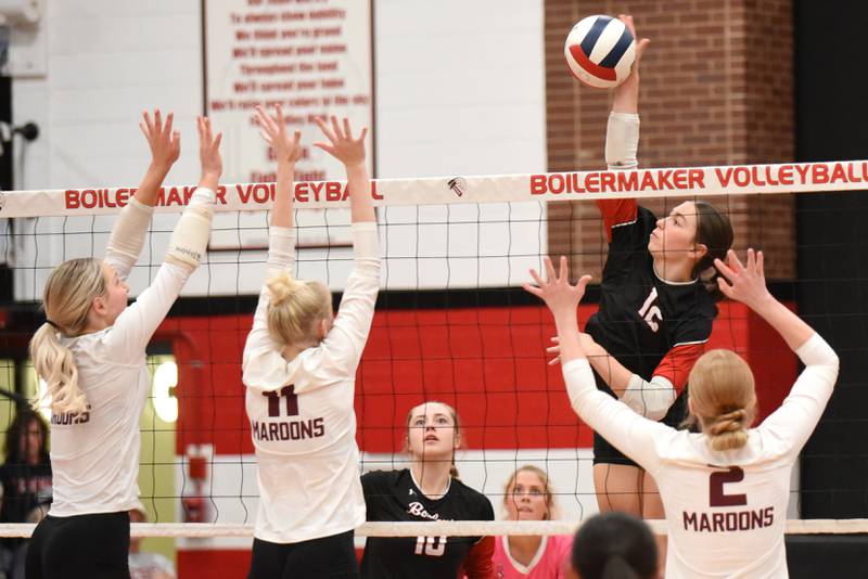 Bradley-Bourbonnais' Olivia Woolman, top right, looks to place a hit over a trio of Champaign Central defenders during a game at Bradley-Bourbonnais Thursday, Oct. 23, 2025.