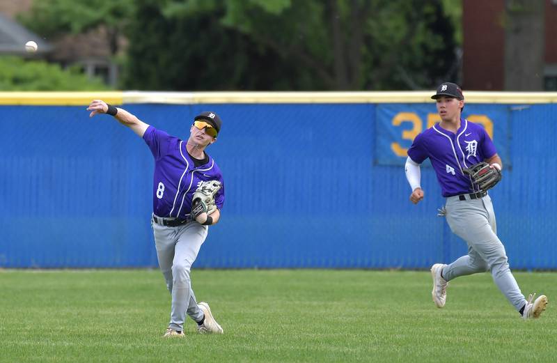 Downers Grove North center fielder Drake Cosenza (8) throws to home plate to hold a runner at third base as left fielder Grant Fordonski backs him up during a game on May 18, 2026 at Lyons Township High School in LaGrange.