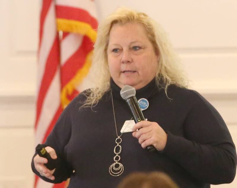 Dawn Trompeter president of OSF Health Care Saint Elizabeth Medical Center (right) delivers a speech to about a hundred people during the OSF Community Breakfast Regional Update on Tuesday, Nov. 28, 2023 at Senicas Oak Ridge in La Salle.