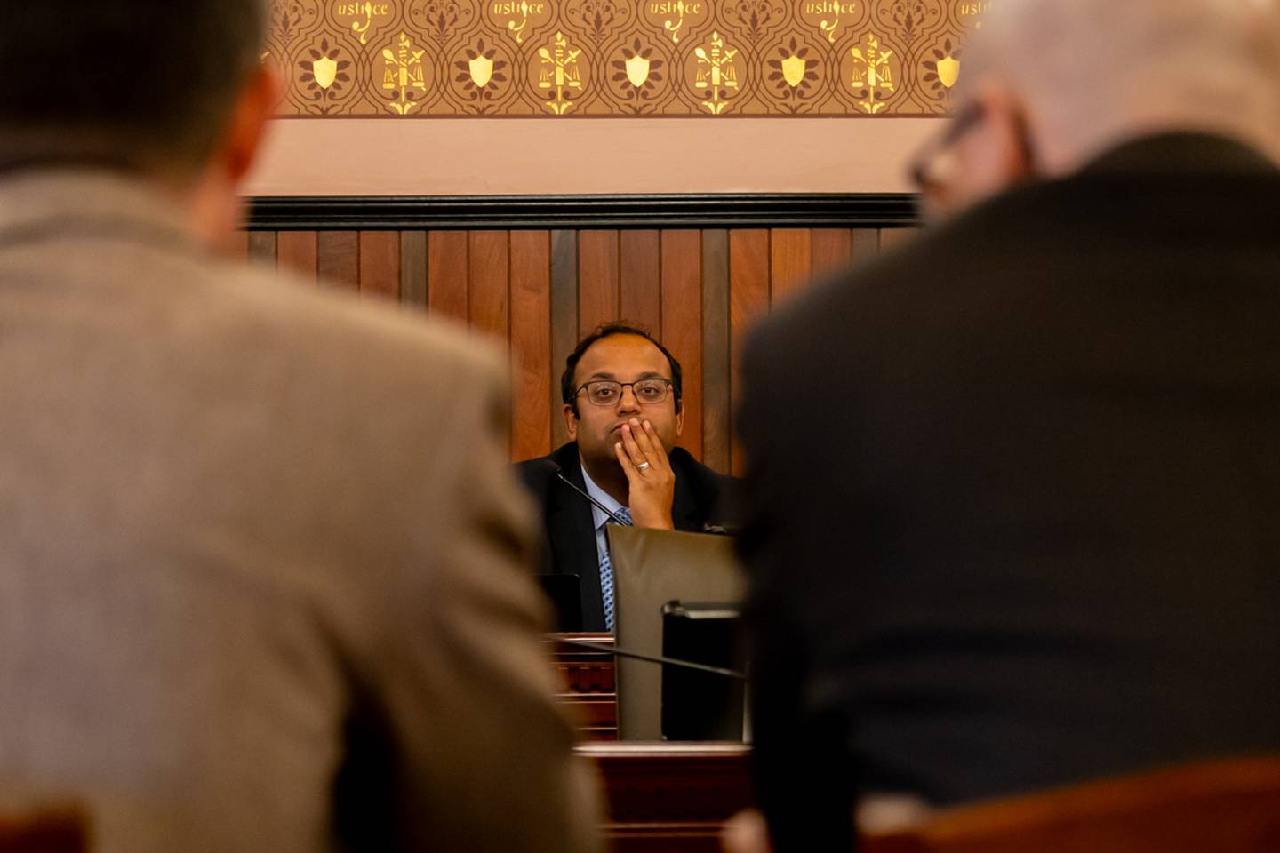 Senate Transportation committee Chair Sen. Ram Villivalam, D-Chicago, watches on as the heads of downstate transit agencies discuss operational issues at a committee hearing.