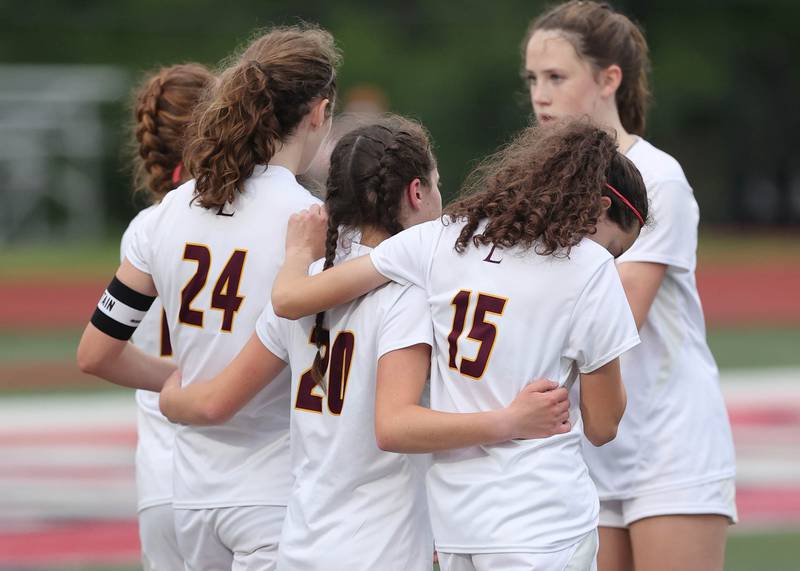 Montini players console each other after losing to Richmond-Burton 1-0 Friday, May 27, 2022, in their IHSA Class 1A state semifinal game at North Central College in Naperville.