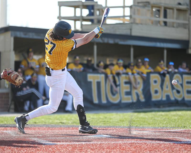 Joliet West's James Love (27) hits a grounder during varsity baseball game between Oswego East at Joliet West.  April 10, 2023.