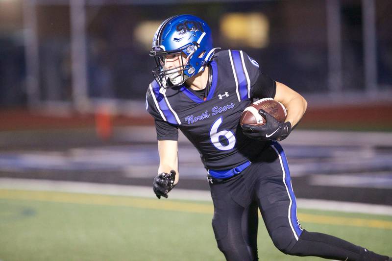 St. Charles North's Keaton Reinke runs the ball for a gain against Geneva on Sept. 12, 2025 in St. Charles.