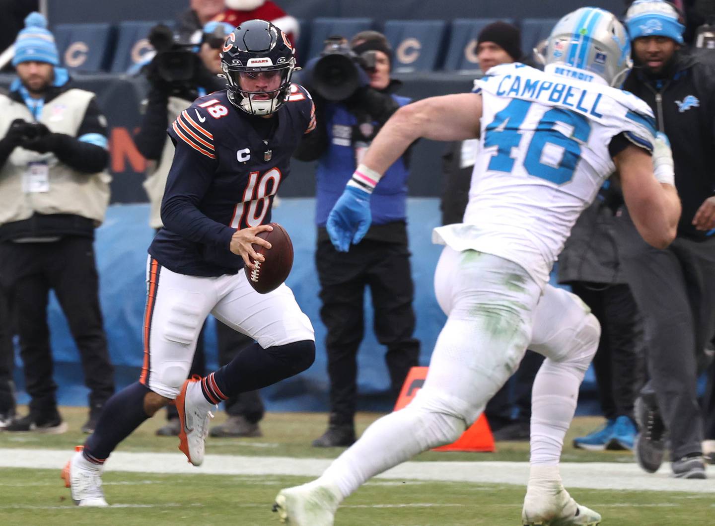 Chicago Bears quarterback Caleb Williams scrambles for yardage as Detroit Lions linebacker Jack Campbell looks to make the tackle during their game Sunday, Dec. 22, 2024, at Soldier Field in Chicago.