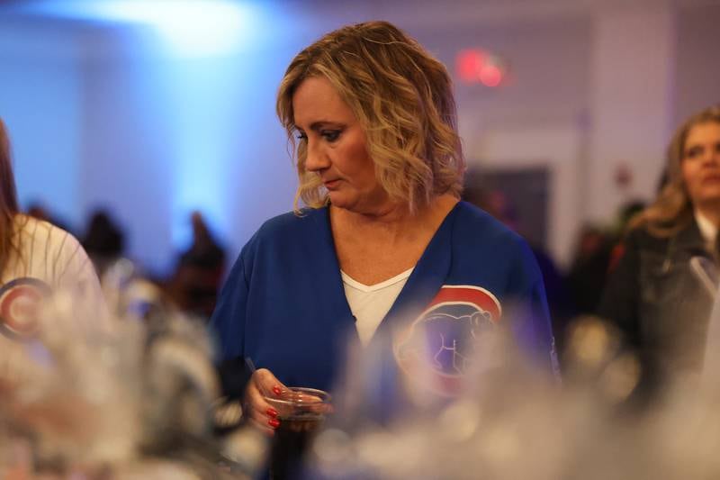 Peggy Hogan of Plainfield looks over the raffle items at the Shorewood HUGS "Sweet Home Chicago" chocolate ball fundraiser in Joliet on Saturday, February 4, 2023.
