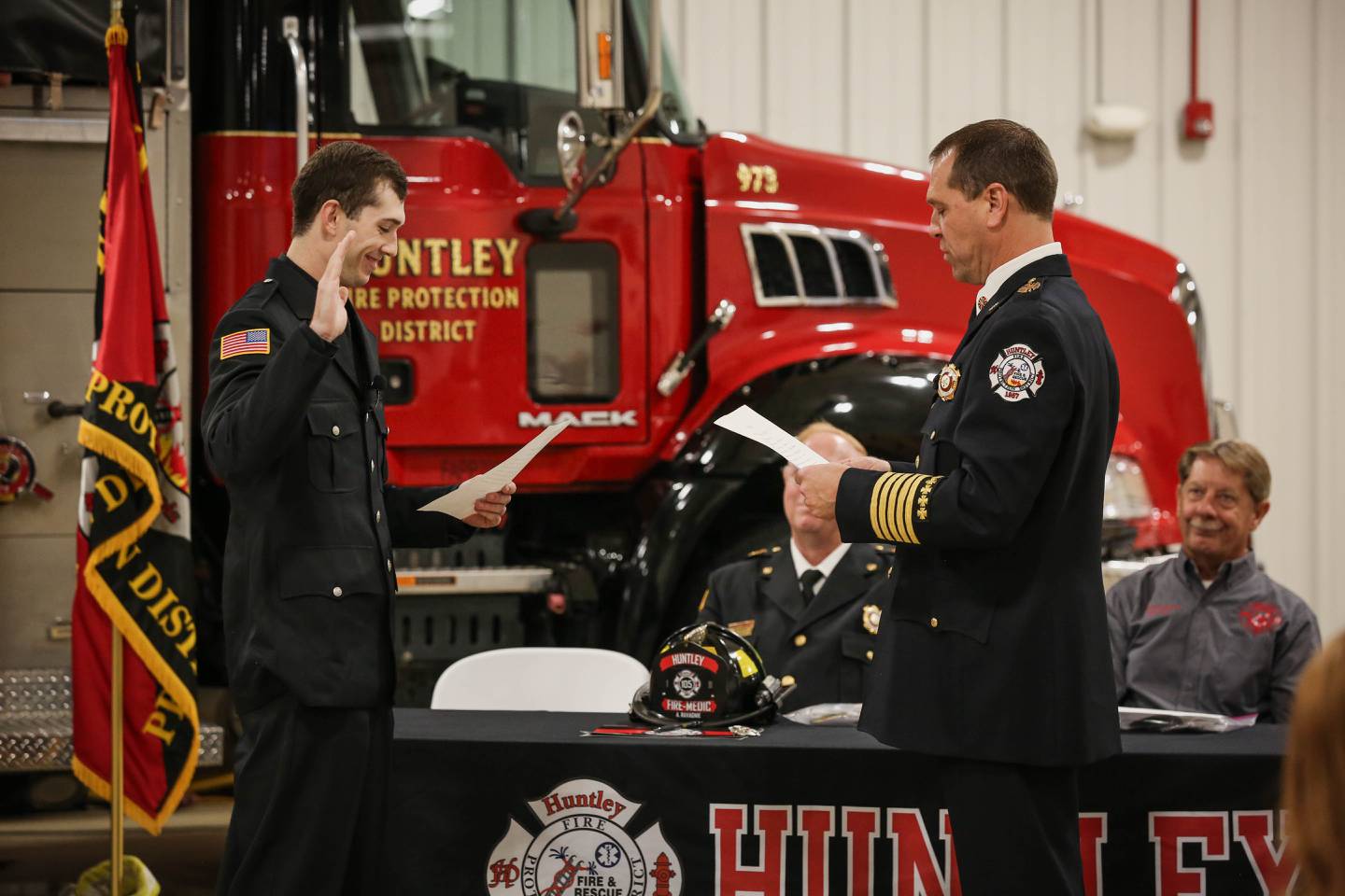 Huntley fire chief Scott Ravagnie, right, swears in his son Alex as a firefighter in Oct. 24. Ravagnie is scheduled to retire May 2025.
