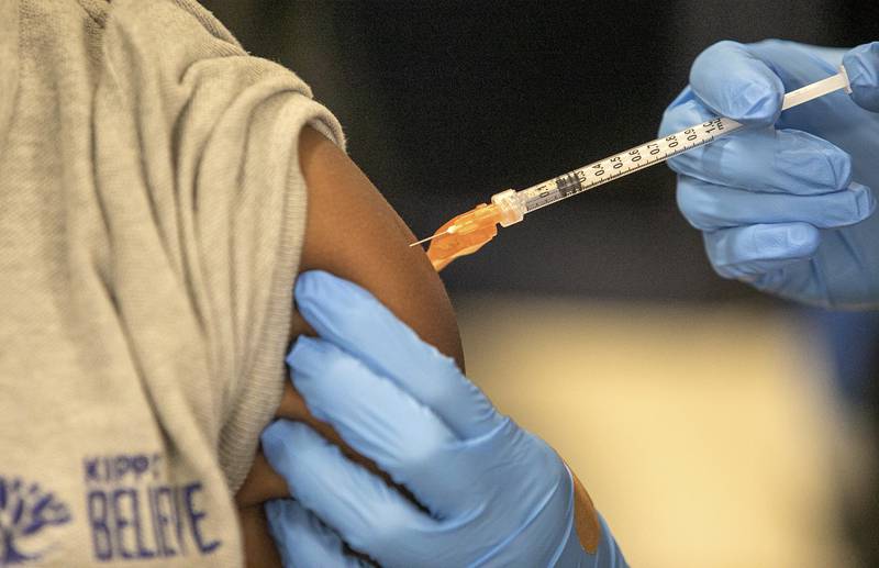 FILE - Medical personnel vaccinate students at a school in New Orleans on Jan. 25, 2022. A Centers for Disease Control and Prevention advisory committee on Thursday, Oct. 20, 2022 voted that the agency should update its recommended immunization schedules to add the COVID-19 vaccine, including to the schedule for children. (AP Photo/Ted Jackson, File)